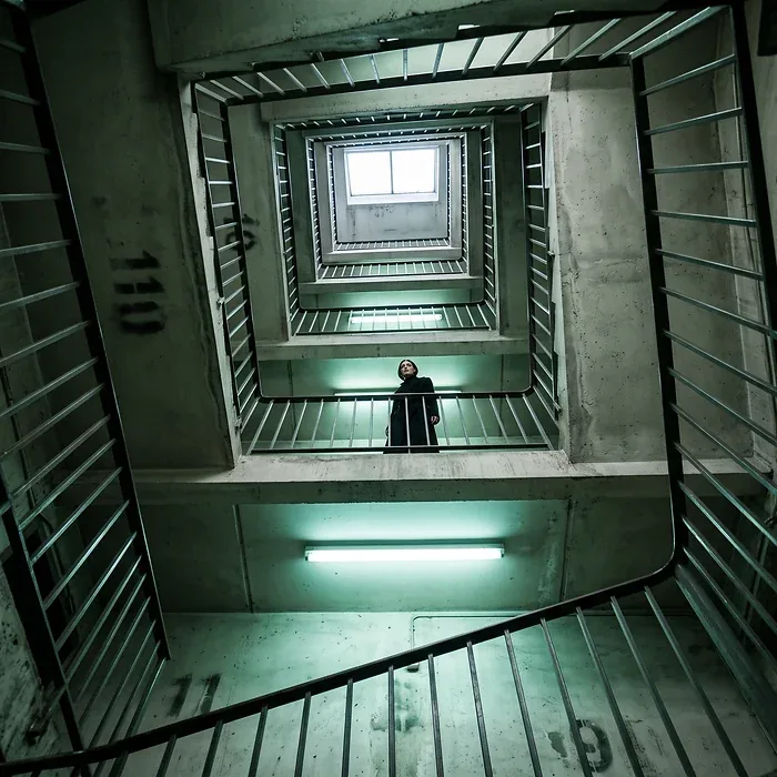 Campaign frame: looking down a green-lit stairwell